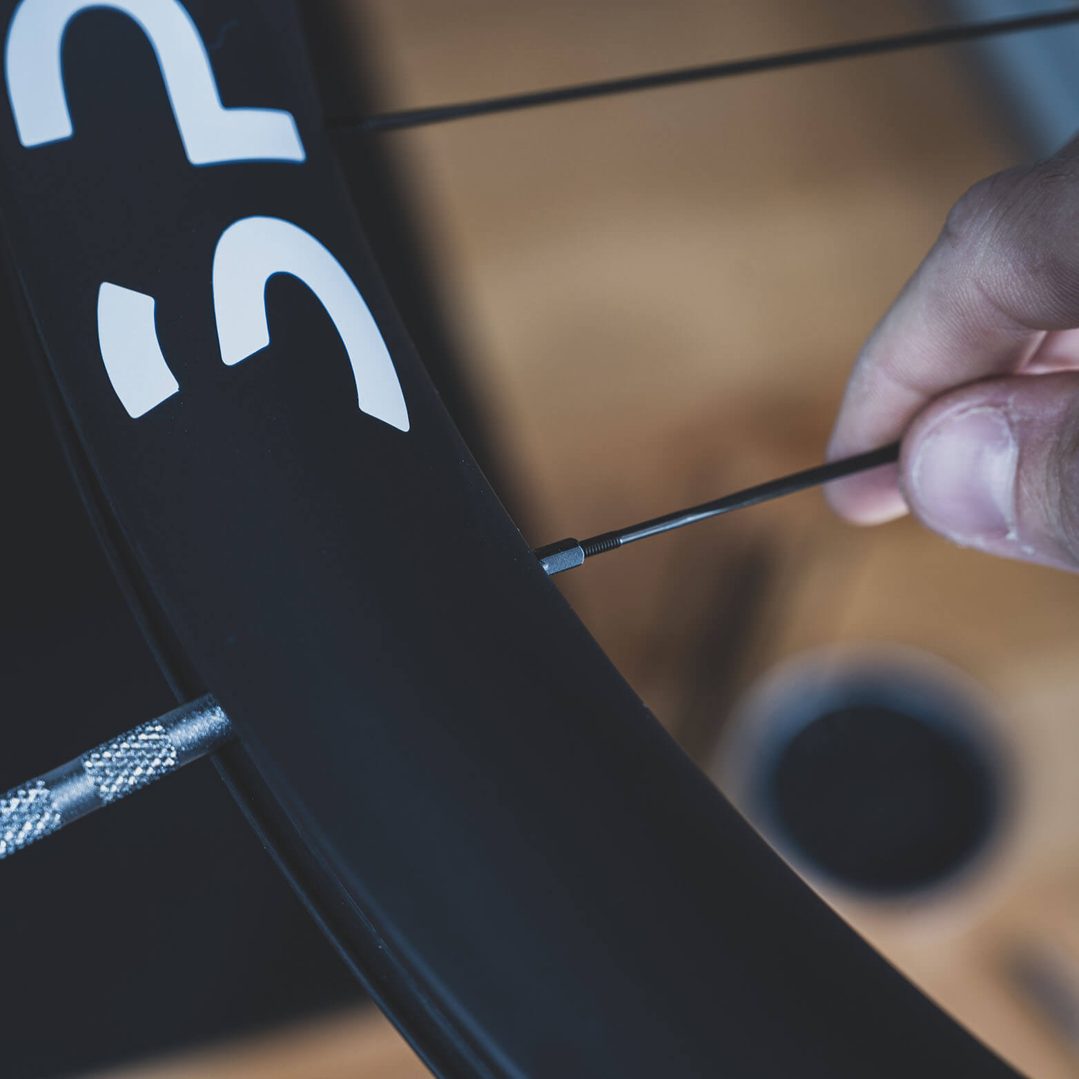 Slowly, single lines, spokes start to form a pattern, an interconnection of a wheelset's backbone.